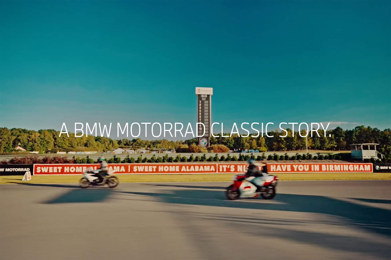 BMW Motorräder unterschiedlicher Epochen präsentieren sich auf einer Rennstrecke in Alabama – in transparenter Schrift schwebt über der Szenerie die Schlagzeile „Eine BMW Motorrad Klassikstory.“