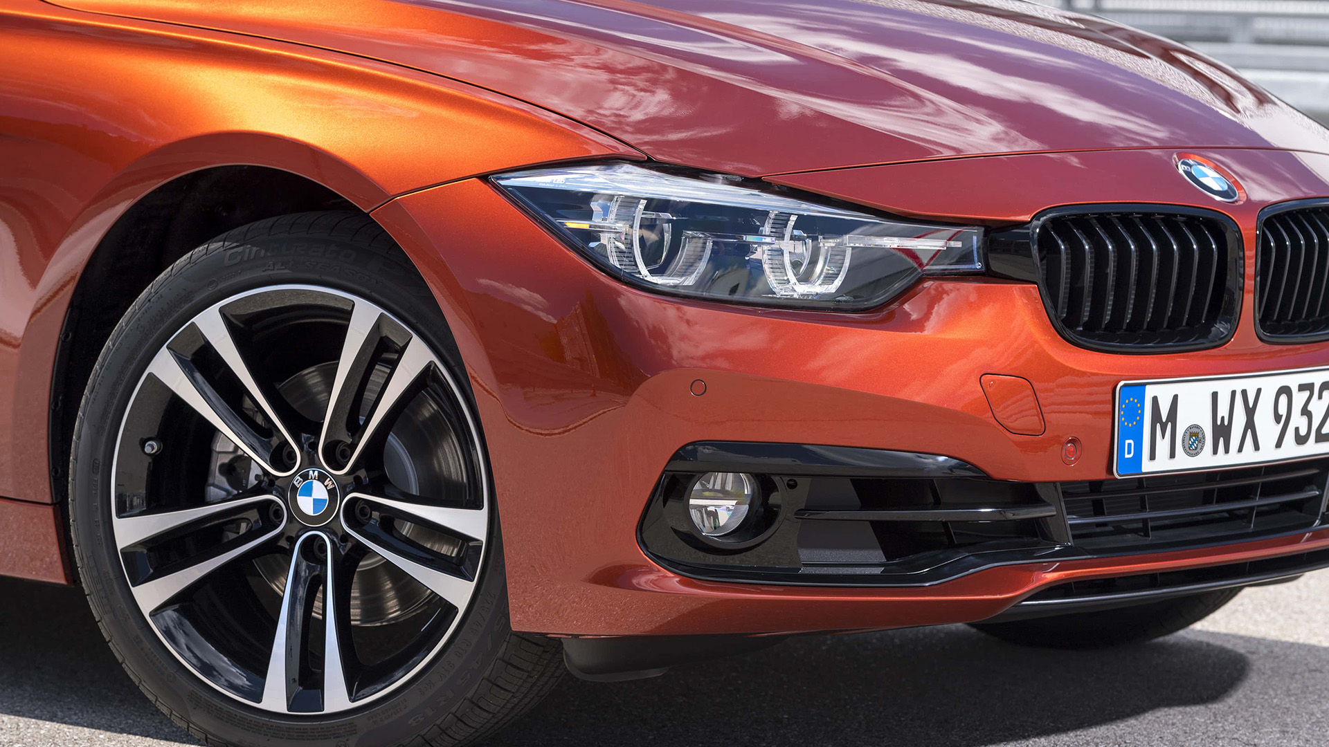 Ansicht der Felge und der Front des orangenen 3er BMWs