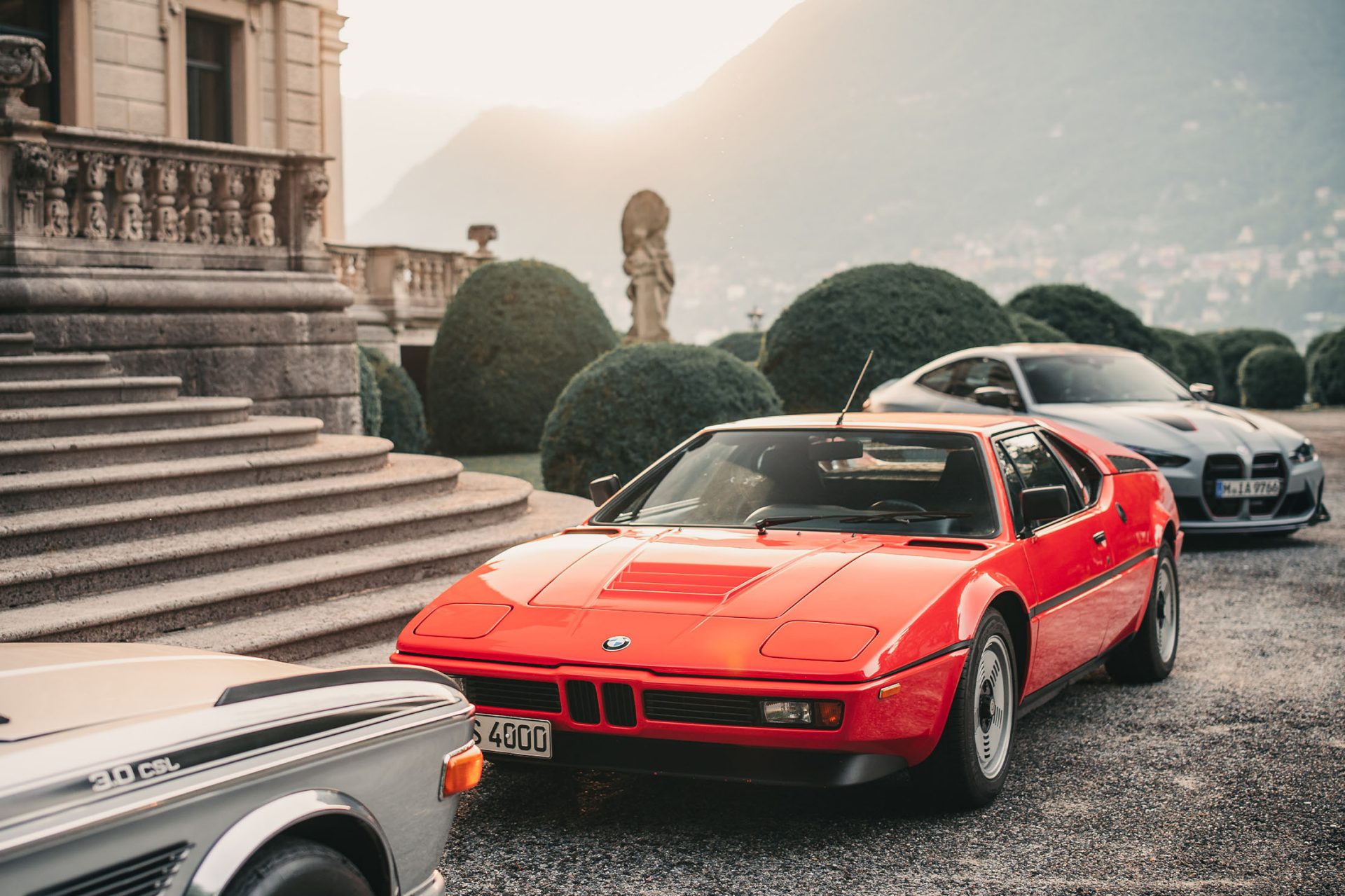 View of the entrance to Villa d'Este with several classic BMWs such as a BMW M1 and a BMW 3.0 CSL.