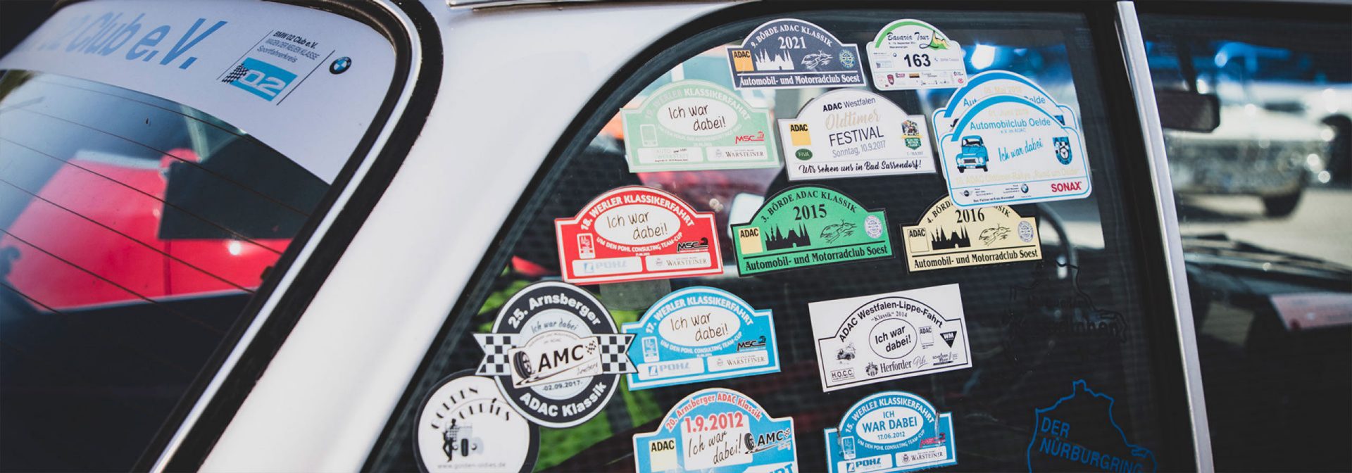 A BMW car with stickers on the side window that shows a creative and individual design.