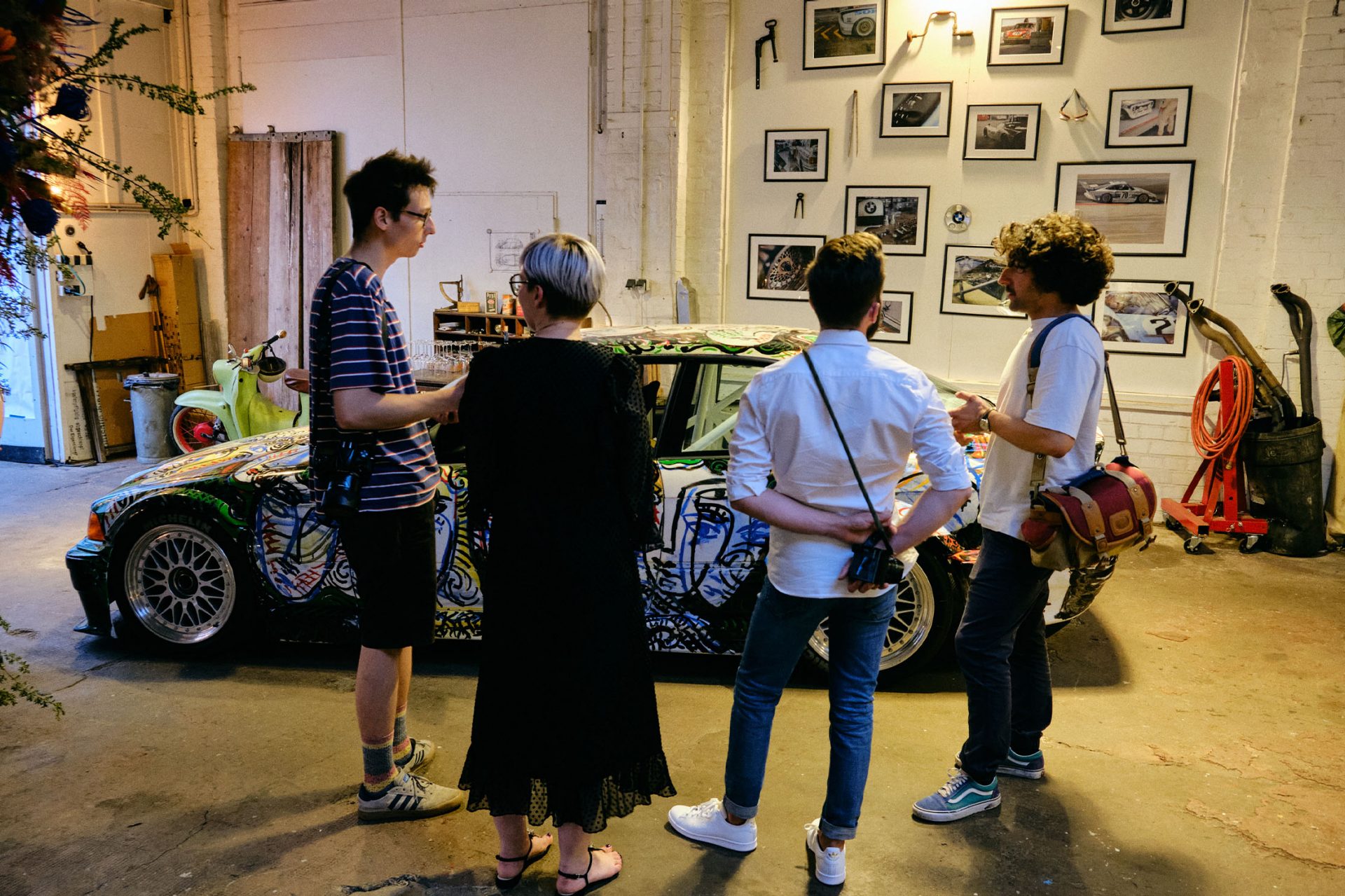 View of a group of visitors admiring a BMW Motorsport vehicle.