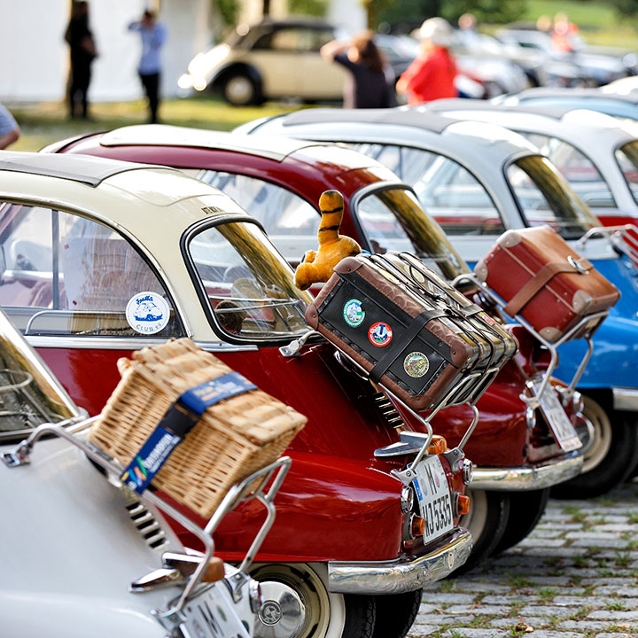 Cars in a row, each with luggage on the roof, symbolize the joy of travel.