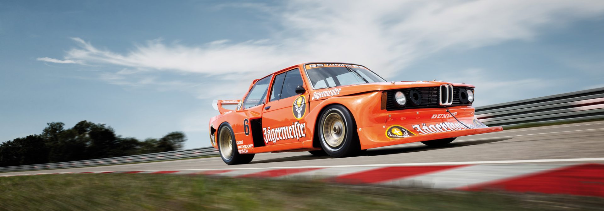 A BMW M20 racing car on the racetrack, ready for an exciting race at high speed.