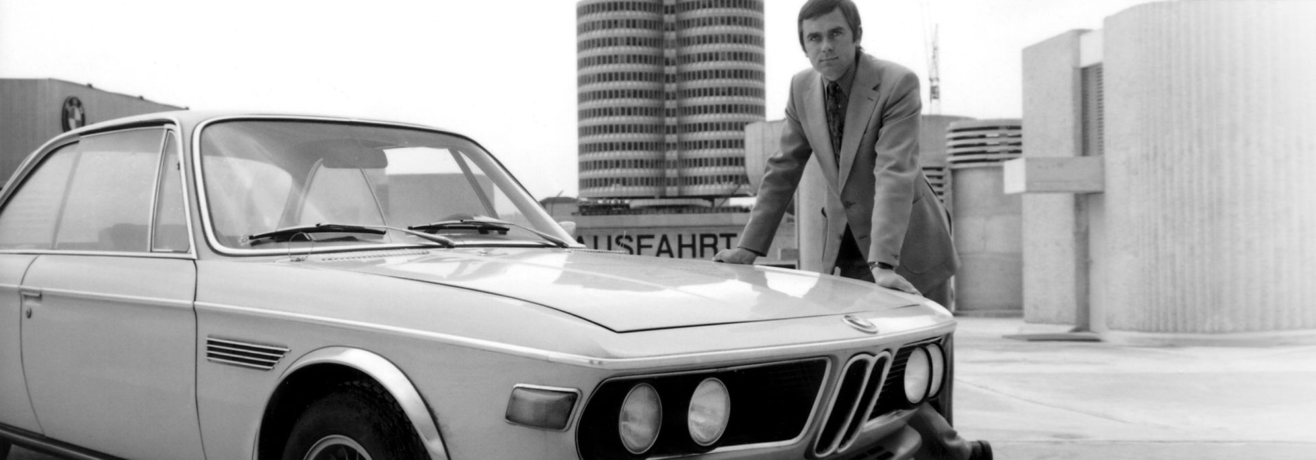 First boss Jochen Neerpasch next to a BMW model.