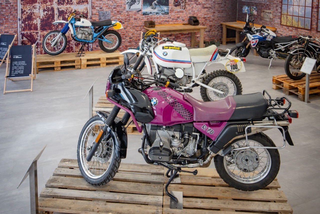 Classic BMW motorcycles on display in a museum.