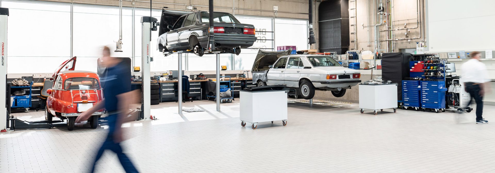 Employees inside the BMW Classic workshop.