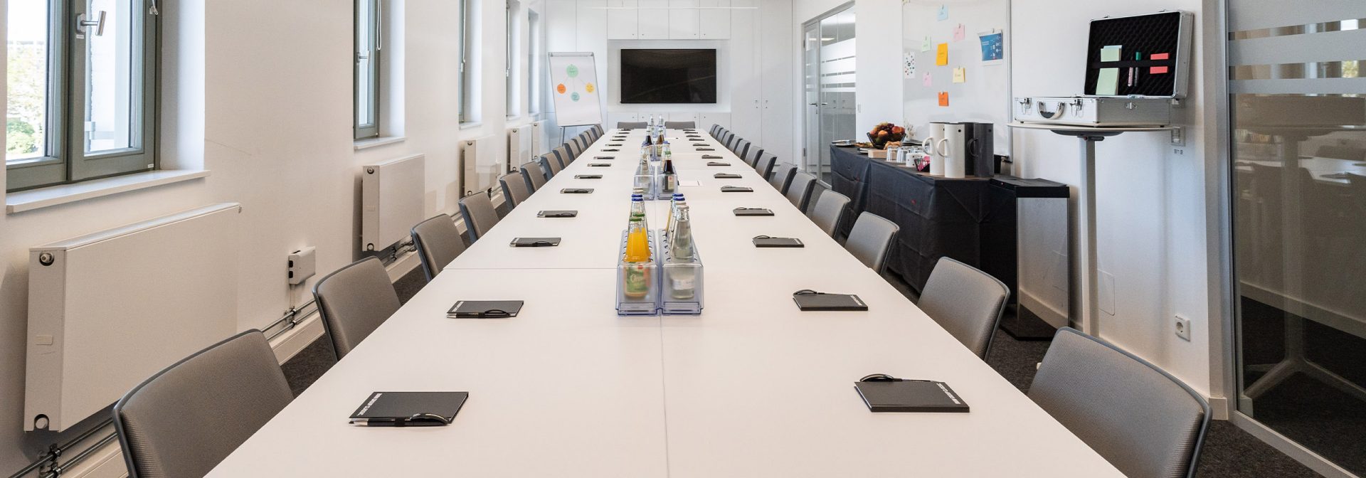 A long table with a television on it, creating an inviting atmosphere for a BMW Event Forum.