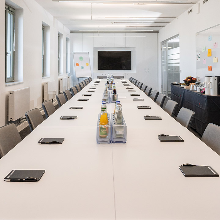 A long table with a television on it, creating an inviting atmosphere for a BMW Event Forum.