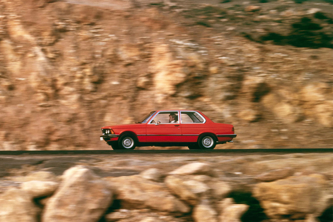 Red Car driving through the mountains