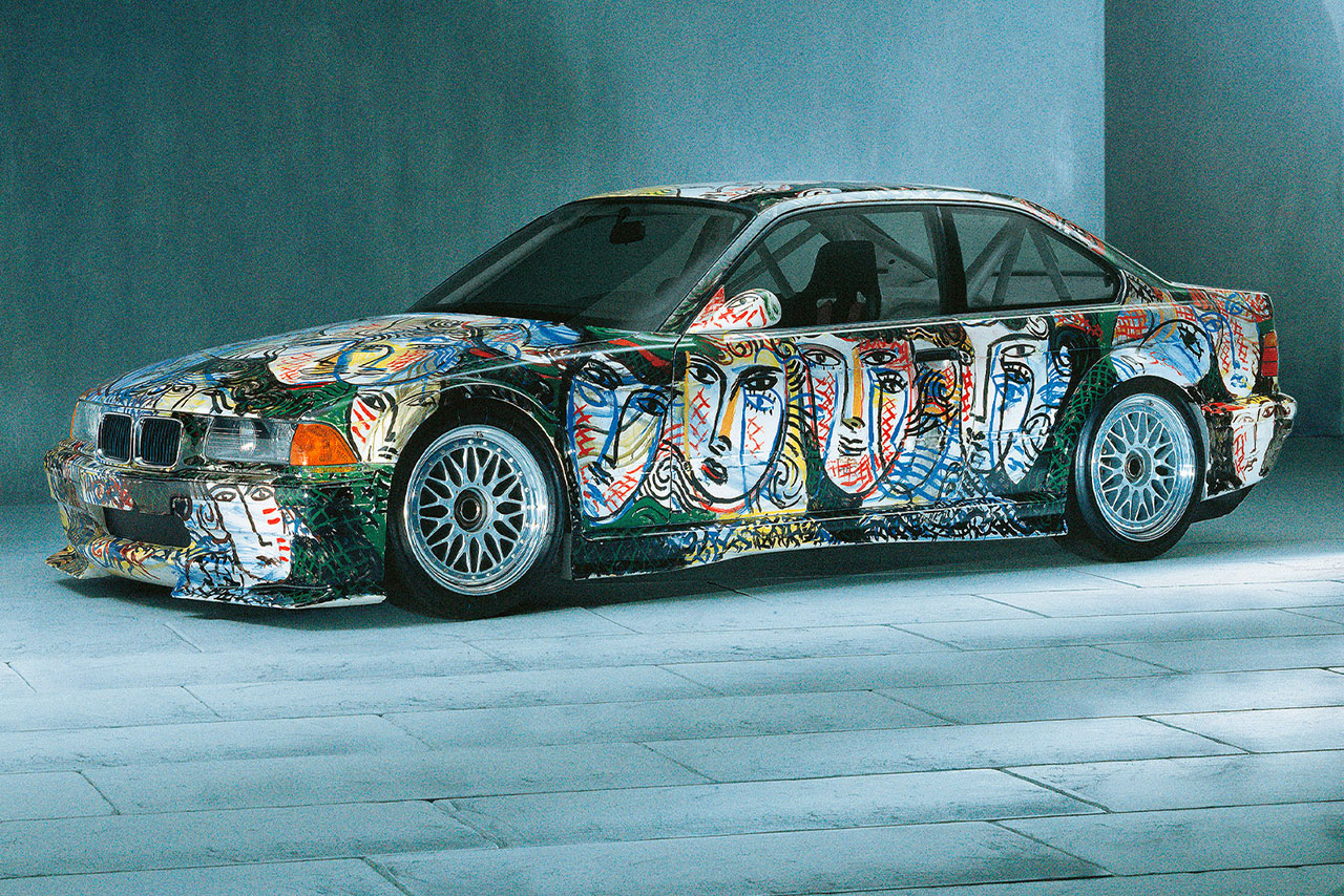 BMW M3 GTR Art Car with many abstract faces painted on it